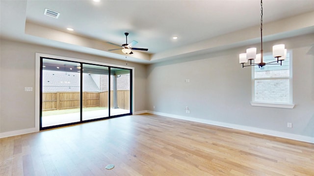 empty room featuring visible vents, baseboards, and light wood-type flooring