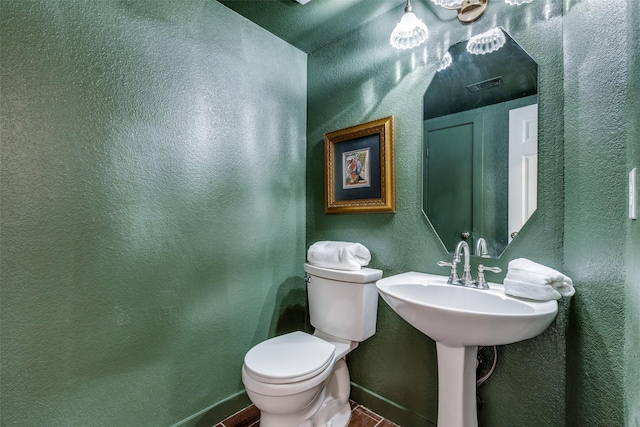 bathroom with visible vents, baseboards, tile patterned flooring, and toilet