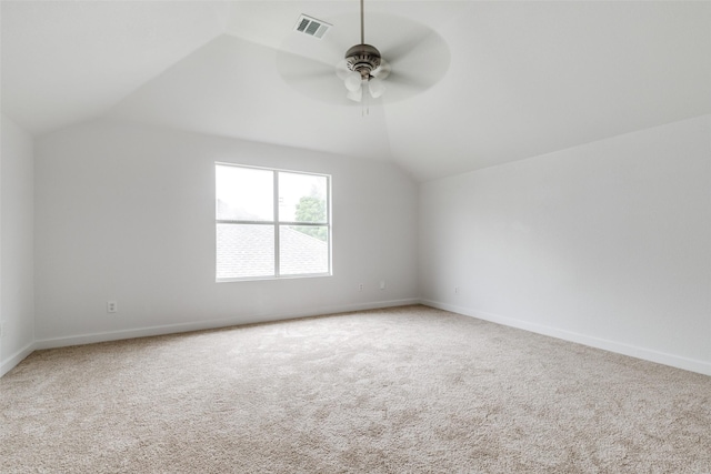additional living space featuring visible vents, lofted ceiling, baseboards, ceiling fan, and carpet
