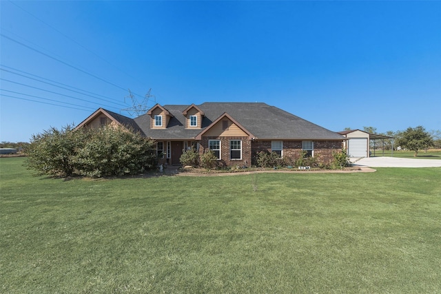 view of front of home featuring brick siding, a front yard, and concrete driveway