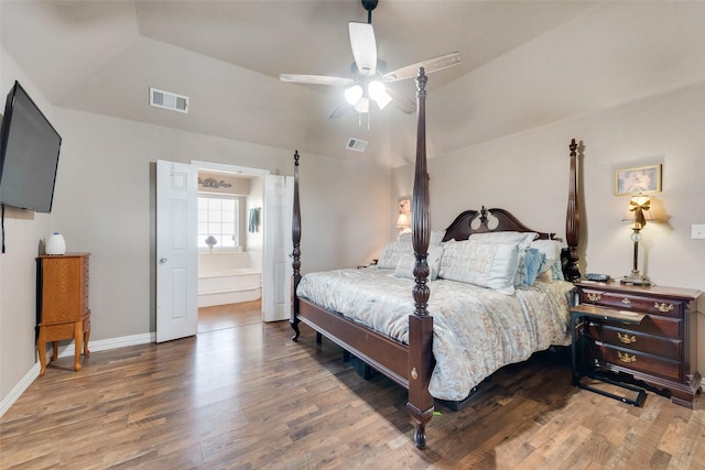 bedroom featuring visible vents, wood finished floors, and vaulted ceiling