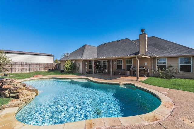 view of pool featuring a lawn, fence, a patio area, and a fenced in pool
