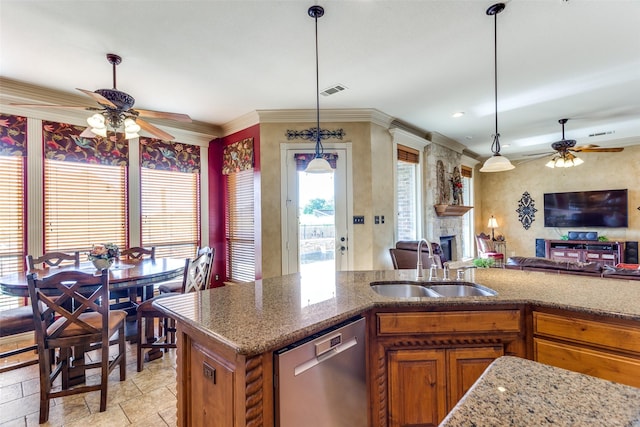 kitchen with brown cabinetry, a sink, ceiling fan, and dishwasher