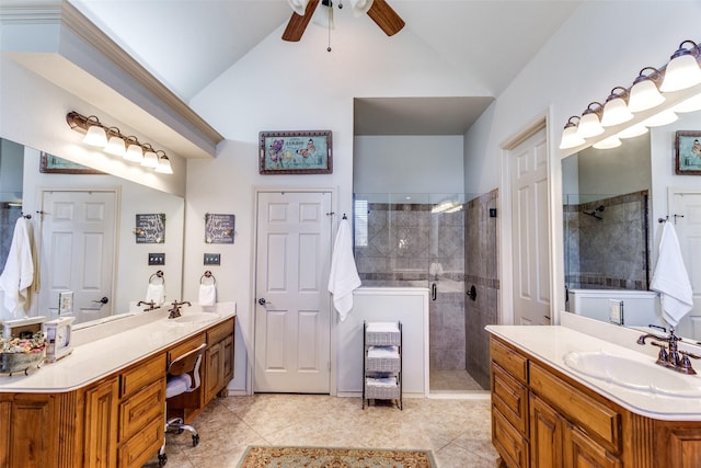 full bathroom featuring a sink, ceiling fan, vaulted ceiling, and tiled shower