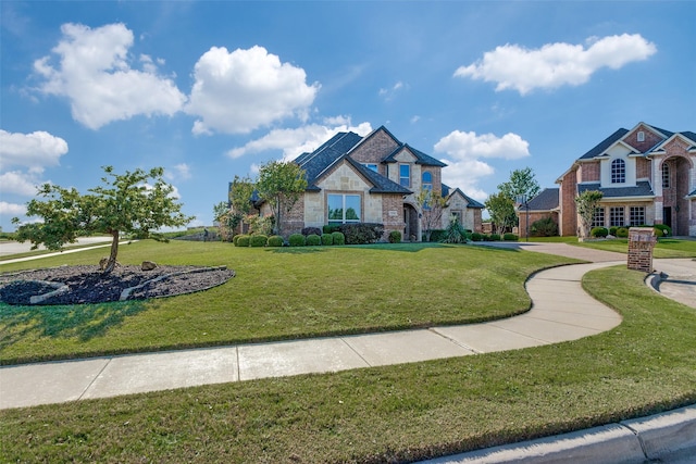craftsman-style house featuring a front lawn and stone siding