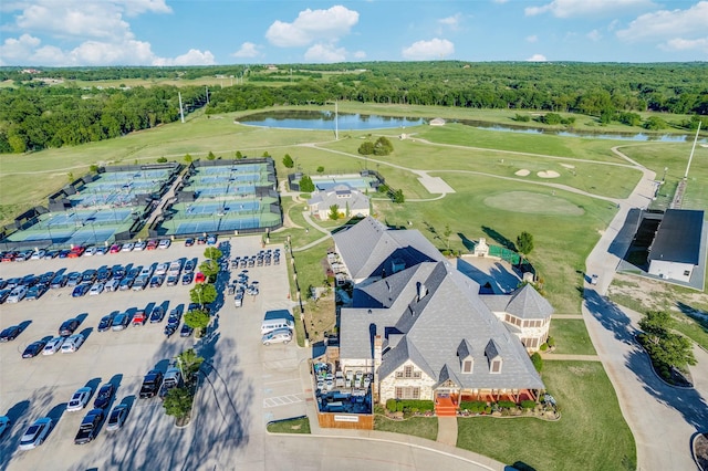 bird's eye view featuring view of golf course, a water view, and a wooded view