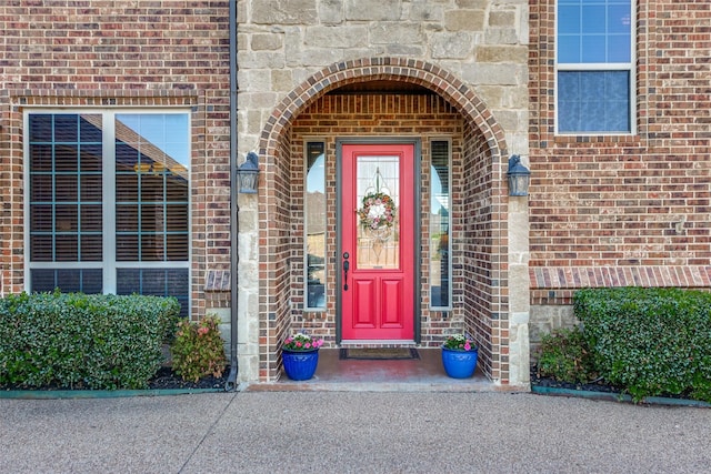 doorway to property with brick siding