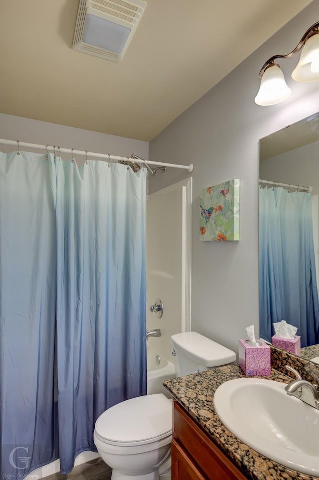 bathroom featuring visible vents, shower / bath combo with shower curtain, toilet, and vanity
