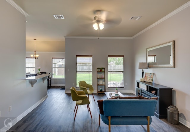 living area featuring visible vents, crown molding, ceiling fan with notable chandelier, and dark wood-style floors