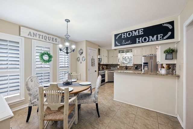 dining room with baseboards, light tile patterned flooring, and a chandelier