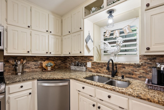 kitchen featuring a sink, light stone counters, backsplash, and stainless steel appliances