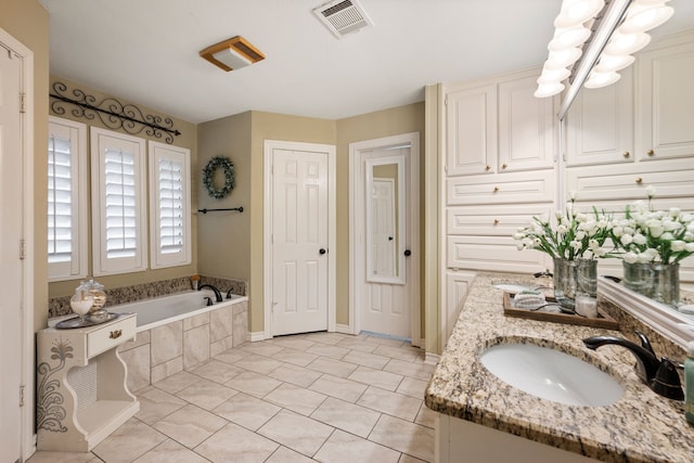 bathroom with visible vents, a garden tub, vanity, tile patterned floors, and a notable chandelier