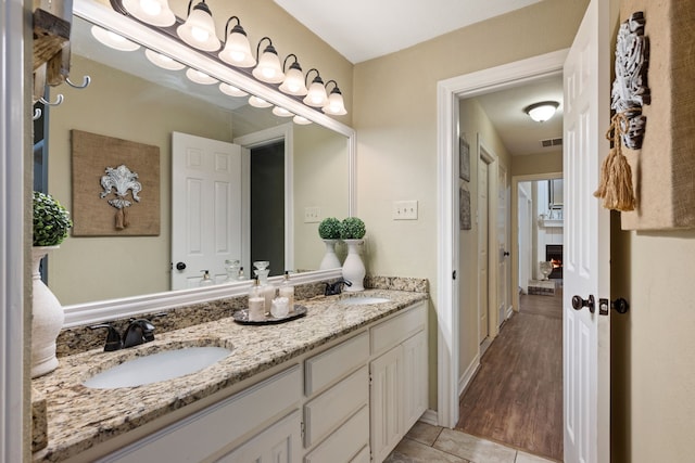 bathroom with double vanity, a sink, tile patterned flooring, and visible vents