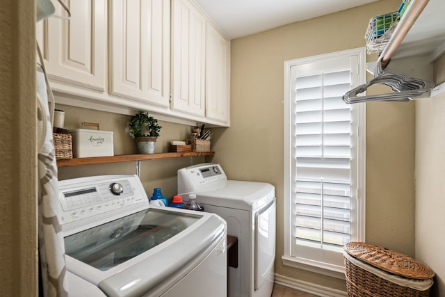 laundry room with cabinet space and separate washer and dryer