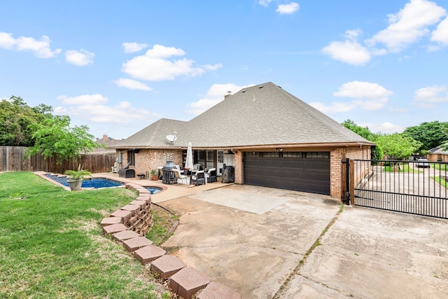 back of house featuring a lawn, brick siding, a fenced backyard, concrete driveway, and an attached garage
