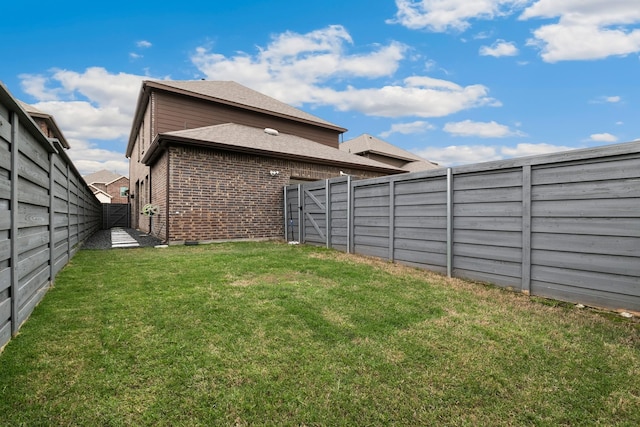 view of yard featuring a gate and a fenced backyard