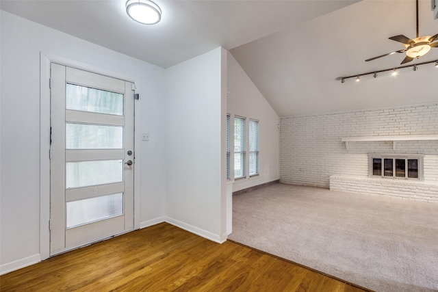10119 Chisholm Trl, Dallas, TX 75243 - unfurnished living room with ceiling fan, wood finished floors, a fireplace, baseboards, and brick wall