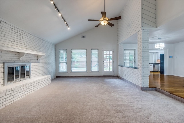 10119 Chisholm Trl, Dallas, TX 75243 - unfurnished living room with carpet flooring, brick wall, a ceiling fan, a fireplace, and high vaulted ceiling