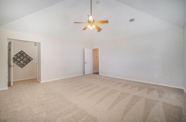 interior space with a ceiling fan, visible vents, vaulted ceiling, baseboards, and light carpet