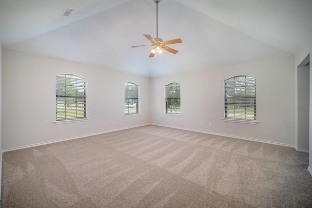 empty room with vaulted ceiling and a wealth of natural light
