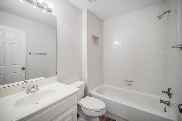 bathroom featuring toilet, bathing tub / shower combination, wood finished floors, and vanity