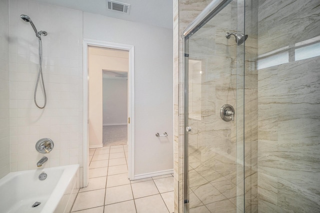 bathroom with visible vents, baseboards, tile patterned floors, and tiled shower / bath