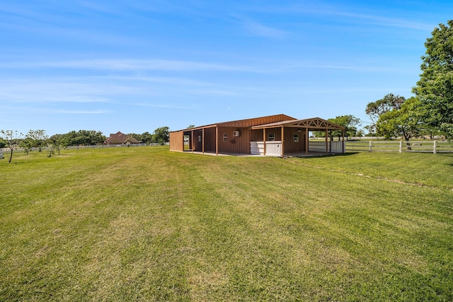 view of yard featuring fence and an outbuilding