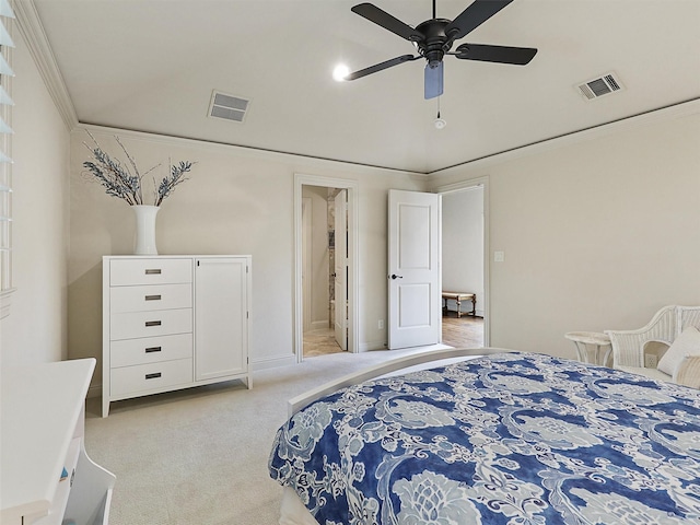 bedroom with visible vents, ornamental molding, baseboards, and light colored carpet