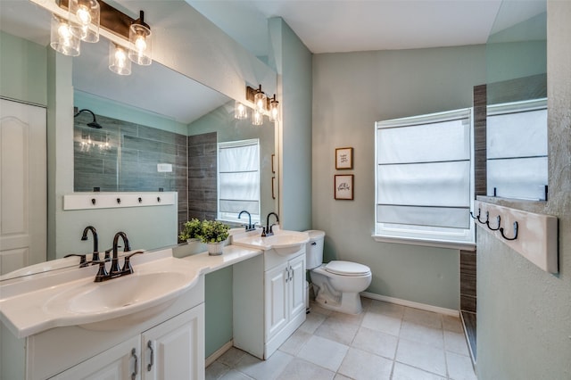 full bath with double vanity, a sink, a wealth of natural light, and tile patterned flooring