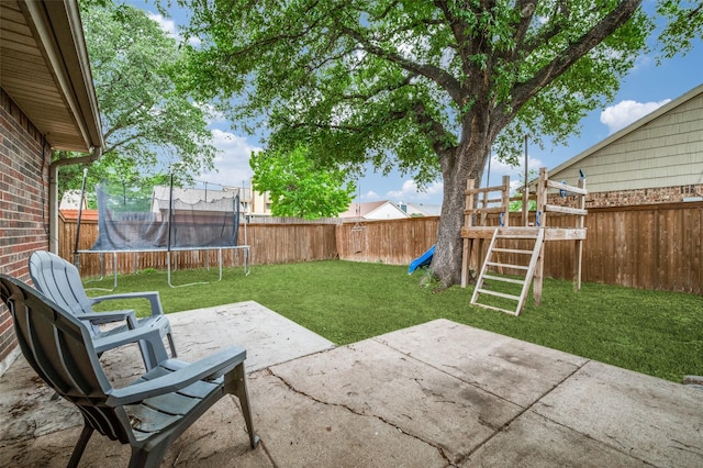 view of yard with a playground, a trampoline, a fenced backyard, and a patio area