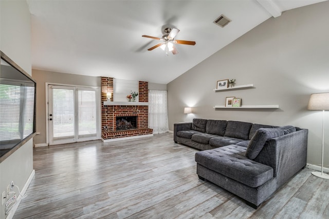 living area featuring lofted ceiling with beams, a ceiling fan, baseboards, wood finished floors, and visible vents