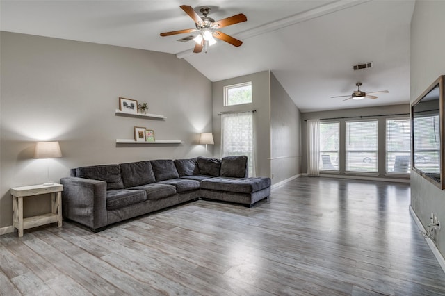 living area featuring visible vents, baseboards, ceiling fan, and wood finished floors