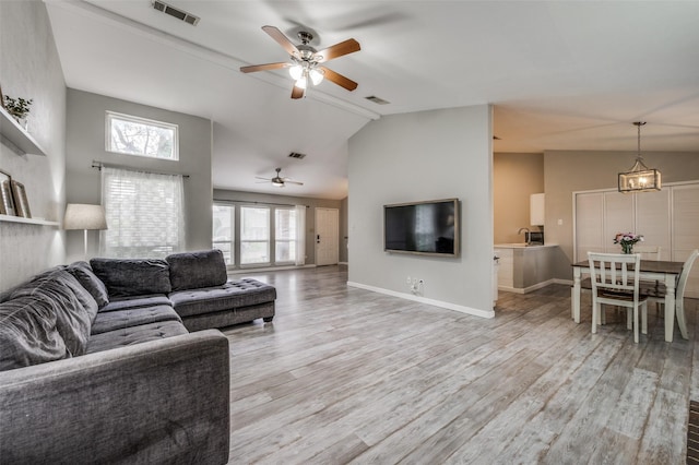 living room with high vaulted ceiling, ceiling fan, light wood finished floors, and visible vents