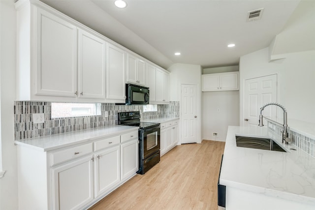 924 Bowie Dr, Lavon, TX 75166 - kitchen featuring black appliances, a sink, decorative backsplash, white cabinetry, and light wood finished floors