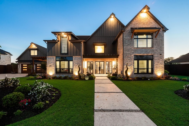 1002 Tokala St, Caddo Mills, TX 75135 - view of front facade featuring a front lawn, board and batten siding, brick siding, and french doors