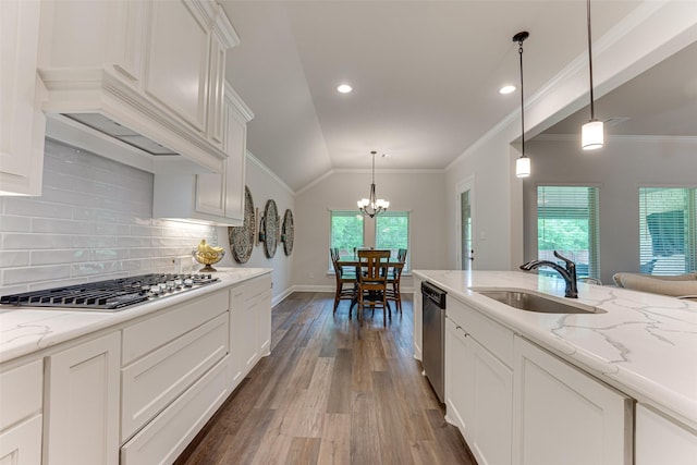 kitchen featuring a chandelier, a sink, dark wood finished floors, appliances with stainless steel finishes, and vaulted ceiling