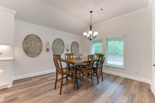 dining area with visible vents, baseboards, a notable chandelier, and light wood-type flooring