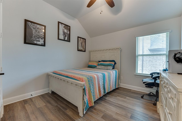 bedroom with a ceiling fan, baseboards, vaulted ceiling, and wood finished floors
