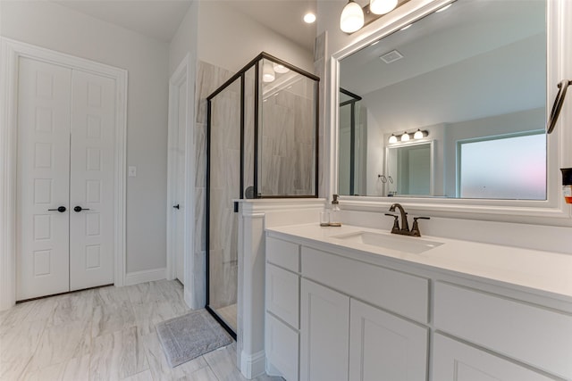 bathroom with vanity, a shower stall, and marble finish floor