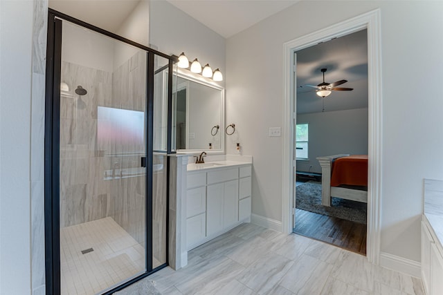ensuite bathroom featuring vanity, a ceiling fan, ensuite bath, and a shower stall