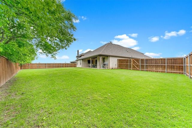 view of yard with a fenced backyard