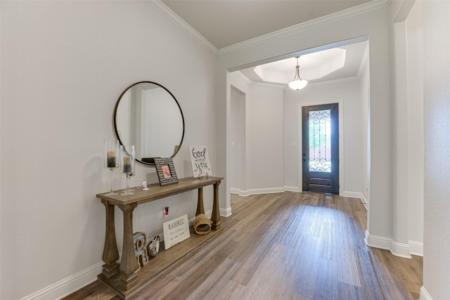 entrance foyer featuring crown molding, baseboards, and wood finished floors