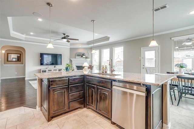 kitchen featuring a ceiling fan, visible vents, stainless steel dishwasher, a sink, and open floor plan