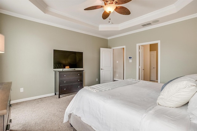 bedroom with carpet floors, ornamental molding, a tray ceiling, and visible vents