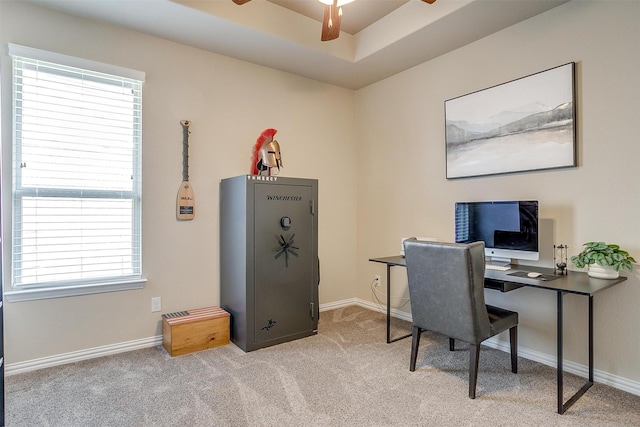 carpeted home office with baseboards and ceiling fan