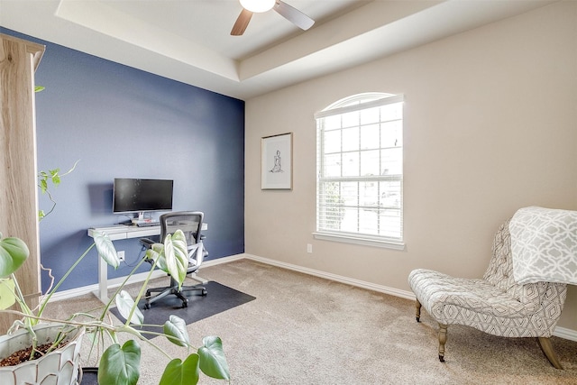 home office featuring a ceiling fan, baseboards, and carpet