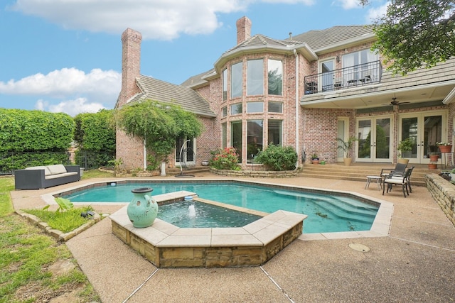 outdoor pool featuring a patio, an in ground hot tub, a ceiling fan, and french doors