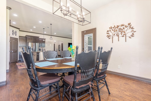dining space with recessed lighting, baseboards, an inviting chandelier, arched walkways, and dark wood-style floors
