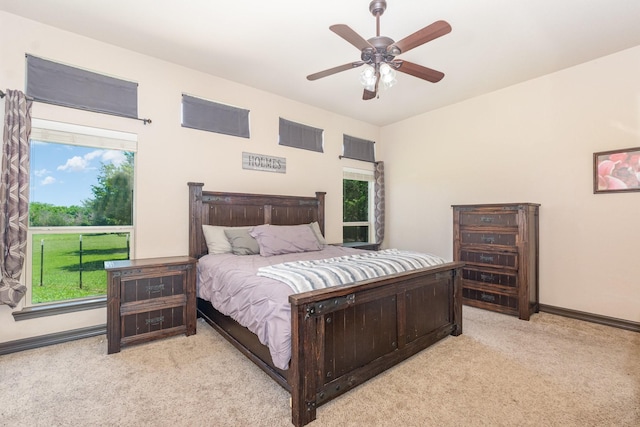 carpeted bedroom with baseboards and a ceiling fan