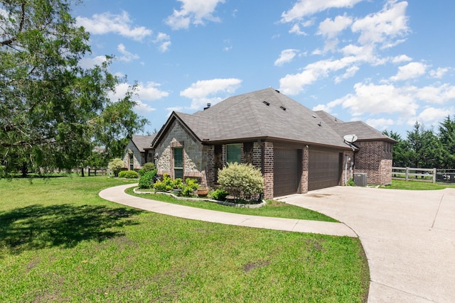 view of front of property with fence, a garage, brick siding, and driveway
